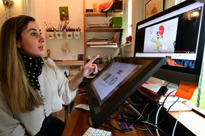 Artist Reem Ali Adeeb gestures while pointing out the Netflix production of "Green Eggs and Ham" on which she worked, in her studio apartment in Los Angeles, California on April 29, 2020
