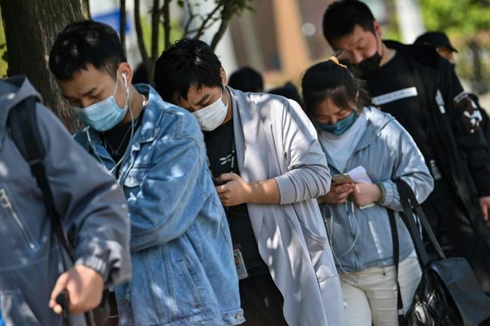 Workers wait in line to collect salaries in Shanghai