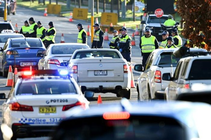 Police in the southern New South Wales border city of Albury check cars crossing from Victoria on July 8 after authorities closed the state border