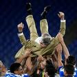 Napoli's players throw club President Aurelio De Laurentiis in the air as they celebrate after the Italian Cup trophy.