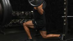 Mid adult man, lifting weights, low section