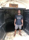 Akwasi Frimpong standing by the famous Cape Coast slave castle in Ghana, May 21, 2019