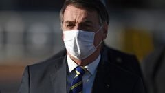 Brazilian President Jair Bolsonaro wears a face mask as he arrives at a flag-raising ceremony at the Alvorada Palace in Brasilia, Brazil, on May 12, 2020