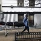 Alisha Narvaez (R) and Lily Sage Weinrieb of International Funeral & Cremation Services transport a body on April 24 in the Harlem neighborhood of New York