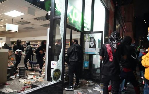 Looters hit stores in New York where the mayor has imposed an overnight curfew
