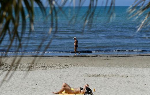People sunbathe in Durres as Albania reopen beaches after weeks of lockdown