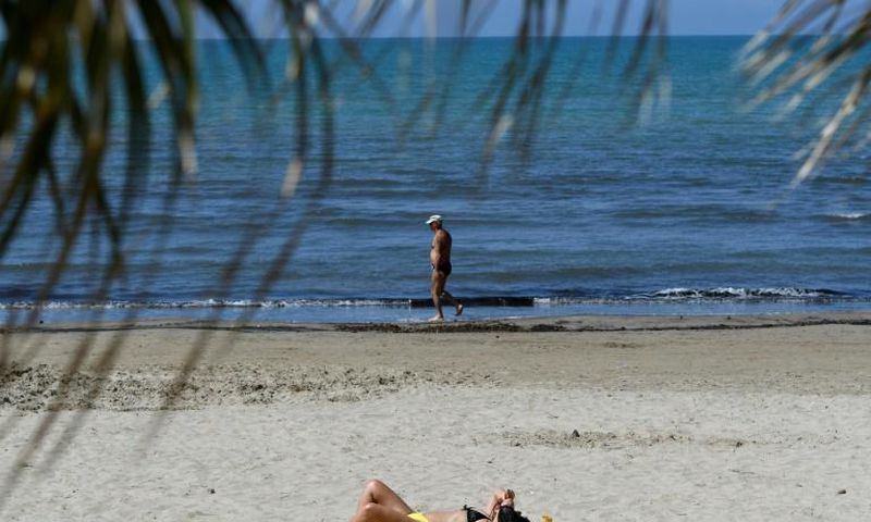 People sunbathe in Durres as Albania reopen beaches after weeks of lockdown