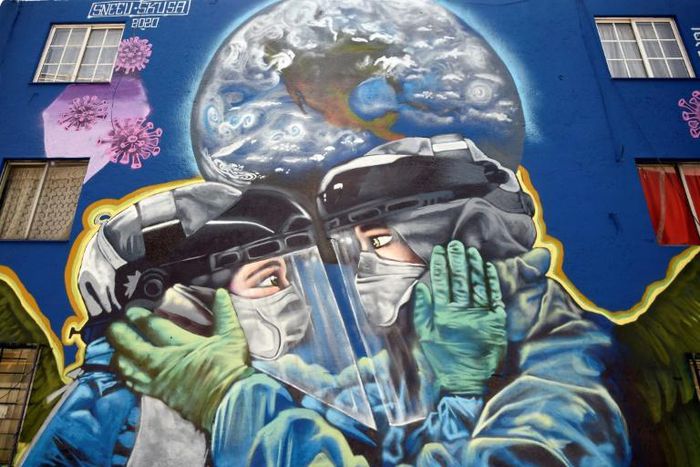The pandemic is gaining ground in Latin America -- including in Mexico, where this mural was painted