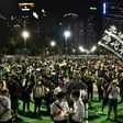 Tens of thousands of protesters defied a ban on public gatherings to hold a candlelight vigil to mark the 1989 Tiananmen Square crackdown