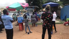 Waakye seller and her customers