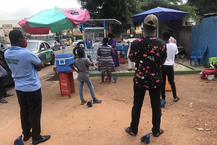 Waakye seller and her customers