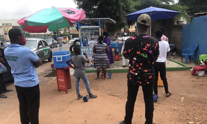 Waakye seller and her customers