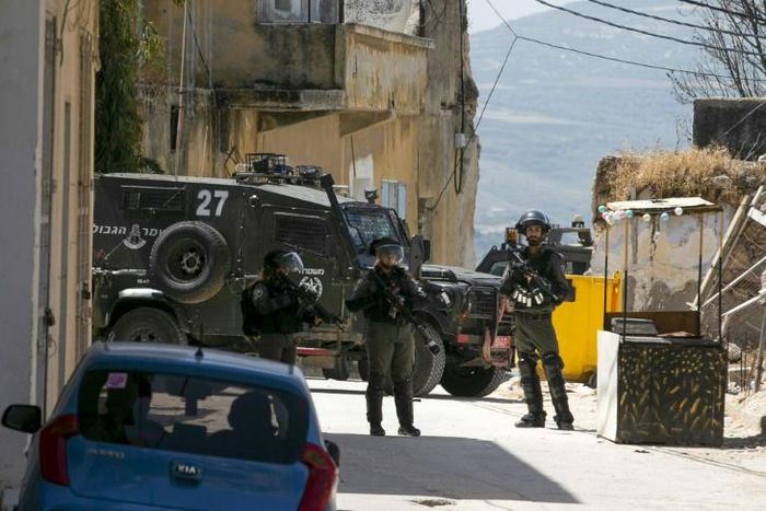 Israeli soldiers hunt for the Palestinian stonethrower believed to be responsible for the death of a comrade during an arrest operation in the village of Yaabad in the occupied West Bank