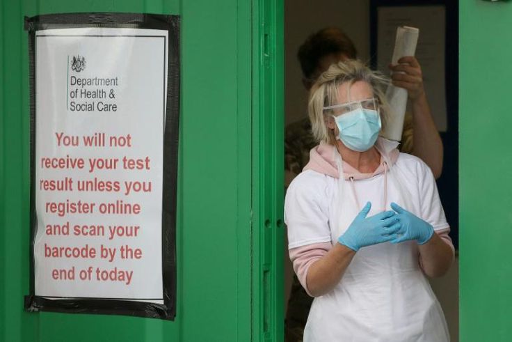 A medical worker prepares to test key workers for the novel coronavirus Covid-19 at a drive-in testing centre at Glasgow Airport