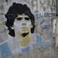 'Hand of God' needed: A woman walks past an image of Diego Maradona during the lockdown in Argentina