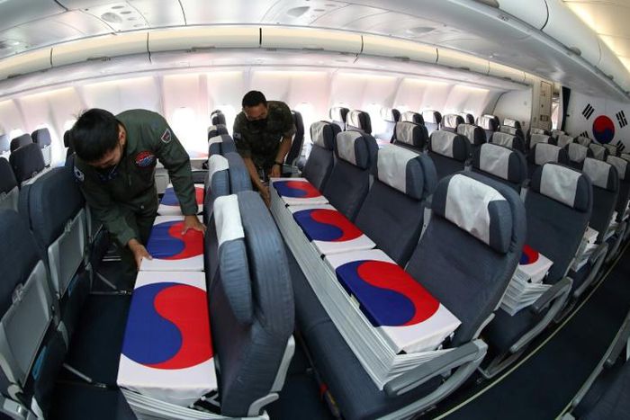 Flag-wrapped coffins containing the remains of nearly 150 South Koreans killed in the Korean War were flown back to Seoul