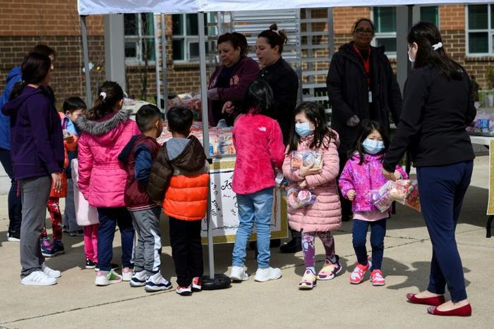 Children pick up free lunch in Arlington, Virginia on March 16, 2020, after schools closed due to coronavirus. Disrupted school lunch programs could be a factor in alarming rises in hunger among US children since the outbreak began, the study says