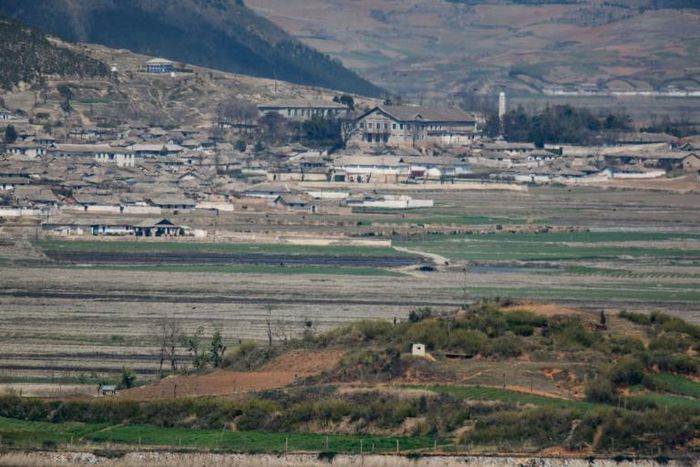 A general view of fields and buildings outside Kaesong in North Korea, seen across the Demilitarized Zone from the South Korean island of Ganghwa