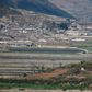 A general view of fields and buildings outside Kaesong in North Korea, seen across the Demilitarized Zone from the South Korean island of Ganghwa