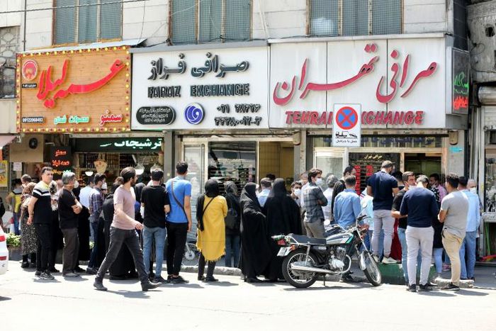 Iranians queue outside a money exchange office in the capital Tehran on Saturday