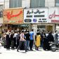 Iranians queue outside a money exchange office in the capital Tehran on Saturday