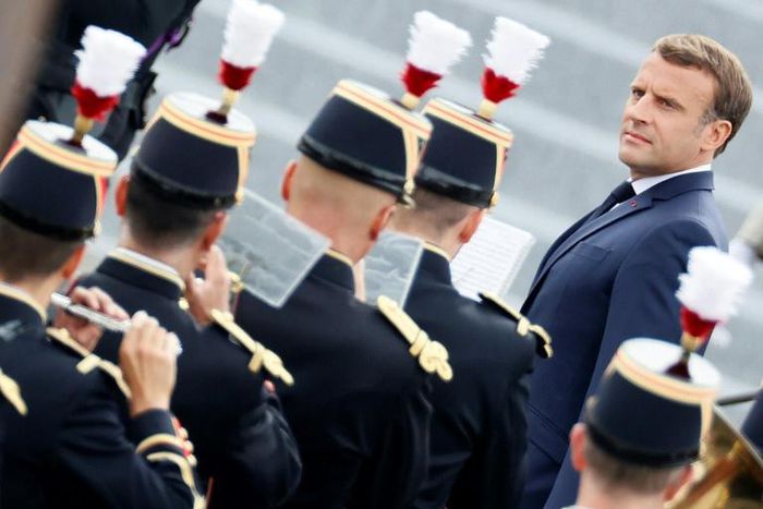 French President Emmanuel Macron reviews the guard of honour during the annual Bastille Day military ceremony in Paris