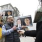 An activist in Vancouver on March 6, 2019 holds photos of Canadians Michael Spavor and Michael Kovrig, who are detained by China, outside British Columbia Supreme Court where Huawei executive Meng Wanzhou appeared