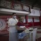 A doctor examines a woman showing symptoms of the novel coronavirus, COVID-19, during a day of free health checks at a samba school in Rio de Janeiro, Brazil, on May 24, 2020