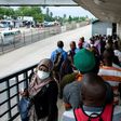 People walk on a pedestrian bridge without adhering to social distancing in Dar es Salaam, Tanzania, in April 2020