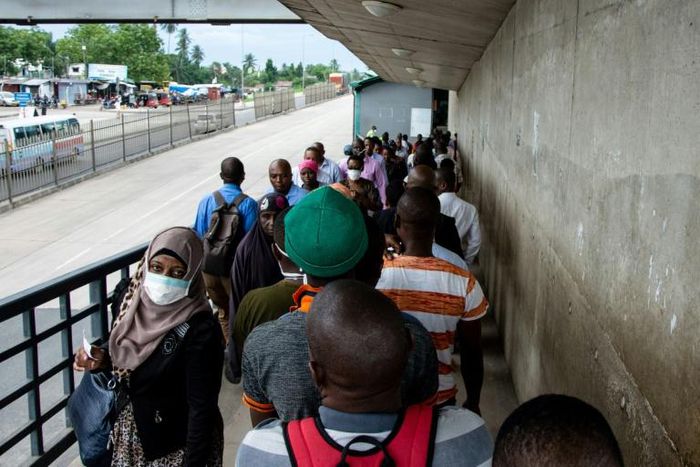 People walk on a pedestrian bridge without adhering to social distancing in Dar es Salaam, Tanzania, in April 2020