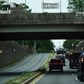 Protesters display signs over President Donald Trump's motorcade in Washington, DC