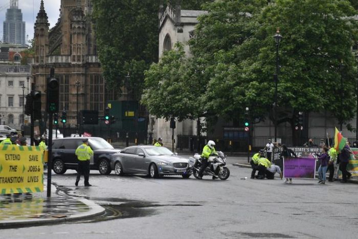 Police detained a protester who ran towards Prime Minister Boris Johnson's car as it left the Houses of Parliament
