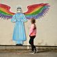 A girl looks at a mural by artist Rachel List paying tribute to NHS staff in Britain
