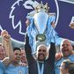 Manchester City manager Pep Guardiola holds up the Premier League trophy
