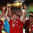 Bayern Munich midfielder Joshua Kimmich with the German Cup after a 4-2 win in Saturday's final in Berlin.