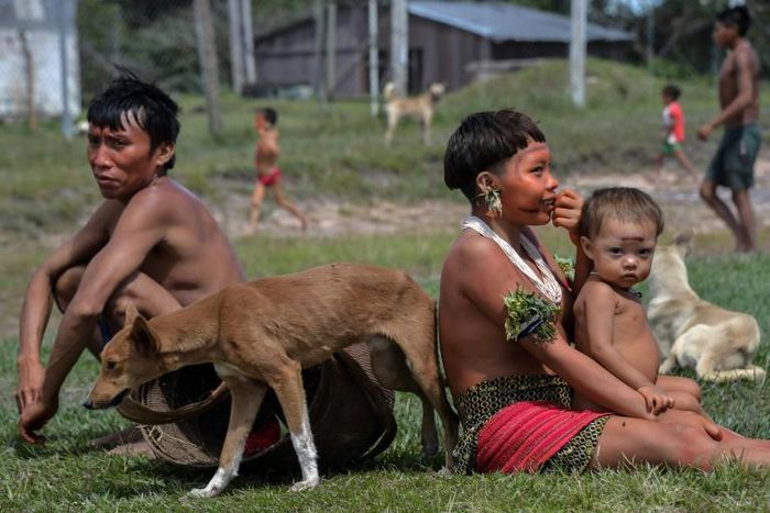 Indigenous Yanomami ethnic group members, seen waiting for COVID-19 tests at the 4th Special Frontier Platoon in Alto Alegre, Roraima state, Brazil, worry that going into cities for medical treatment will mean cutting them off from their culture