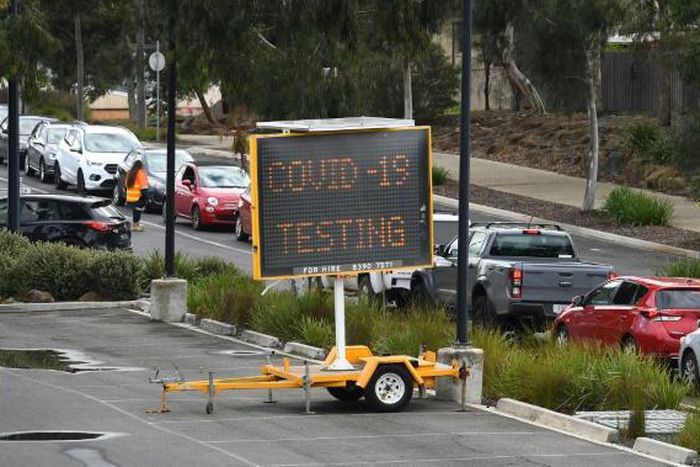 A long queue of cars wait at a drive-through COVID-19 testing site in Melbourne