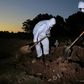 Workers wear protective clothing to bury a COVID-19 victim at the Sao Franciso Xavier cemetery in Rio de Janeiro, Brazil on May 29, 2020