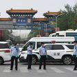 Police guard a Beijing market linked to a new coronavirus cluster