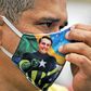 Brazilian president Jair Bolsonaro, whose image can be seen on this person's face mask, has further diluted a law mandating such masks in his country as it struggles with the coronavirus pandemic