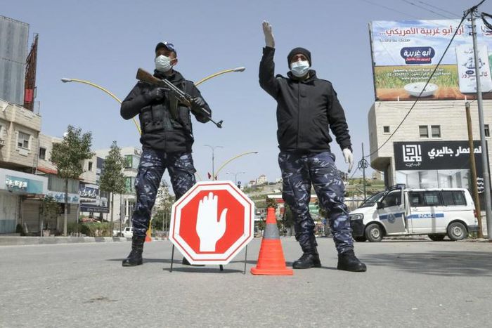 Palestinian security forces man a checkpoint at a key entrance to the city of Hebron earlier this year