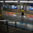 A woman stands at the Sumare subway station during the  COVID-19 pandemic in Sao Paulo, Brazil