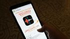 A woman in Egypt checks an Instagram account for reporting allegations of sexual harassment and misconduct