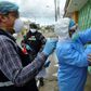 Health ministry personnel test a woman for the novel coronavirus in northern Guayaquil, Ecuador, on April 19, 2020