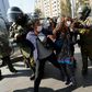 Riot police arrest demostrators in Santiago on Friday after breaking up a May Day protest that contravened social distancing rules