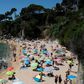 People enjoy a day out at the beach in Platja D'Aro near Girona -- Spaniards endured one of the world's toughest lockdowns for three months from March 2020