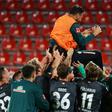 BClaudio Pizarro, 41, is cheered by his Werder Bremen team-mates as he retired after their relegation/promotion play-off on Monday at Heidenheim.