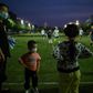 People play football in a field in Wuhan, in China's central Hubei province after coronavirus restrictions were eased