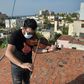 Cuban violinist William Roblejo rehearses on the rooftop of his house in Havana