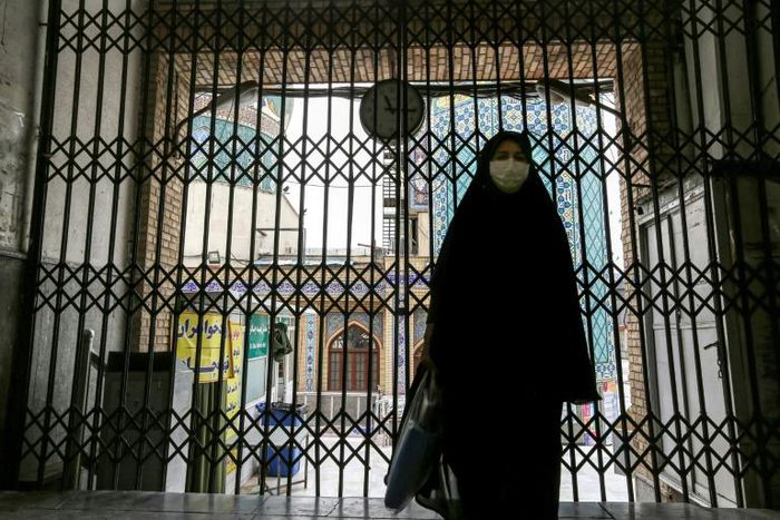 A woman walks past the closed gate of the Imamzadeh Saleh mosque in the Iranian capital Tehran on April 25. On Monday Iran reopened some places of worship in parts of the country deemed at low risk from the coronavirus